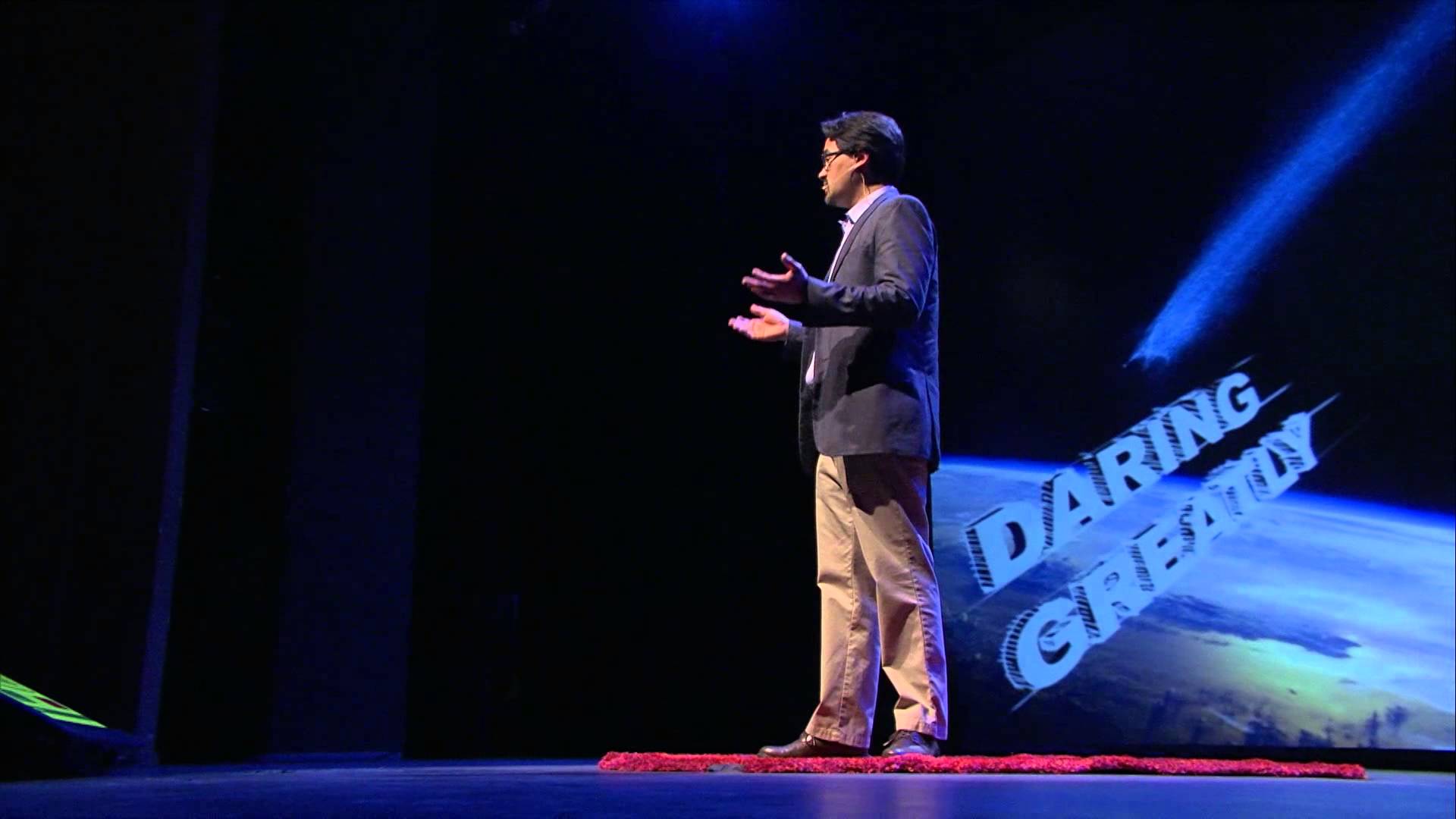 Bill Watson speaking on an auditorium stage