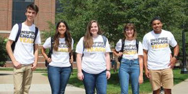 Ambassadors in matching shirts outside of Beering Hall