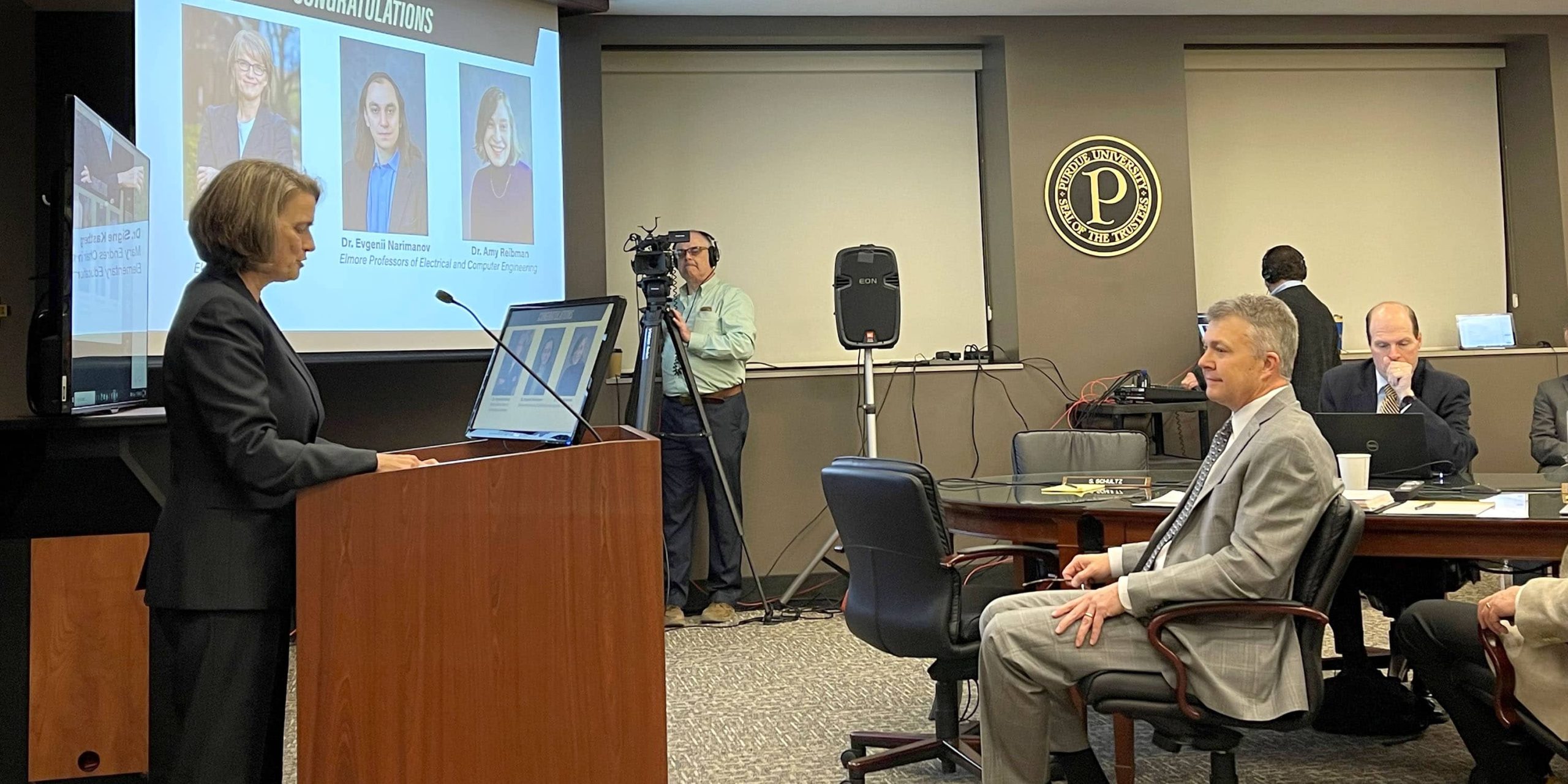 Dr. Signe Kastberg speaking at podium.