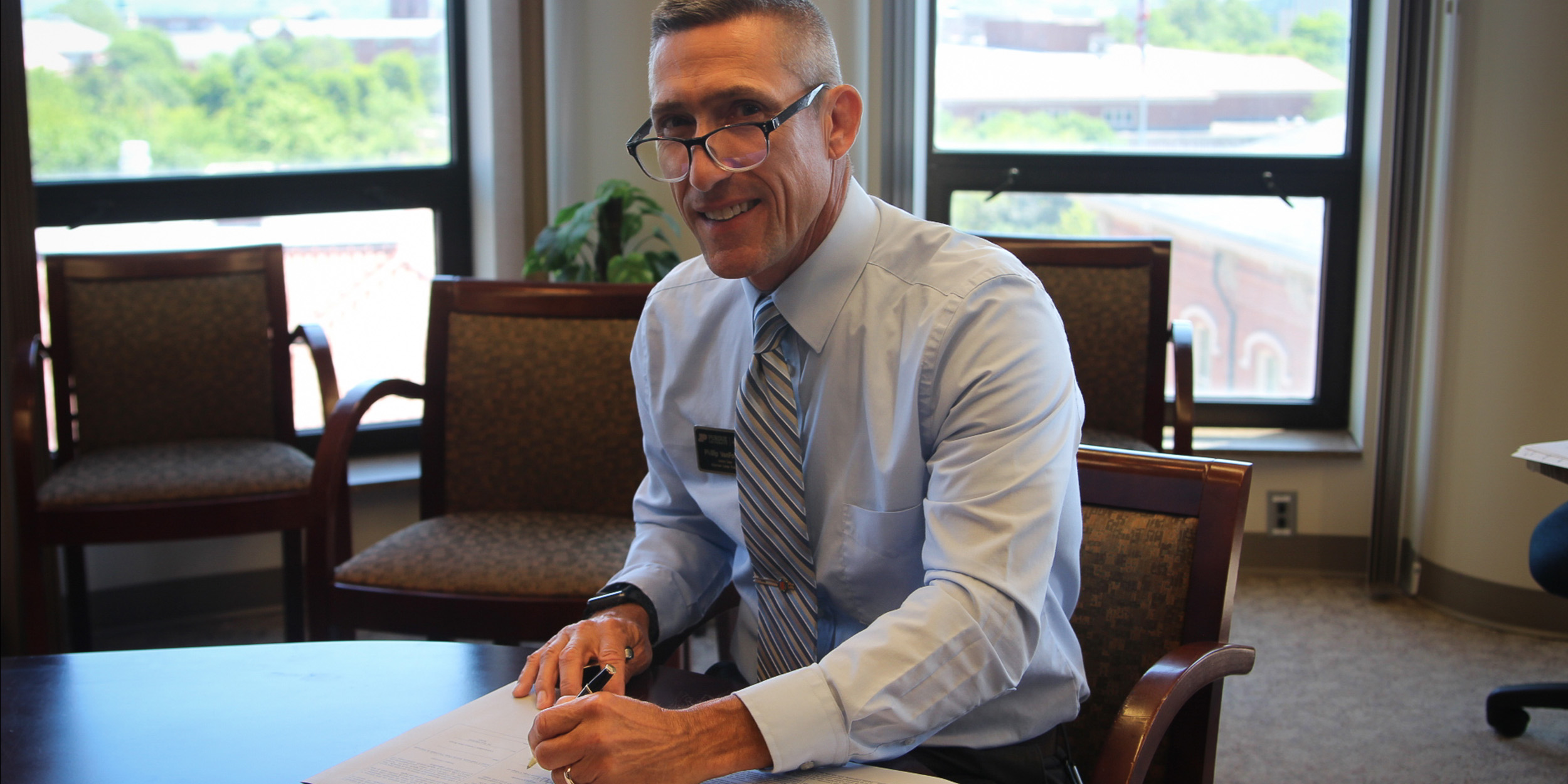 Phil Vanfossen signing document