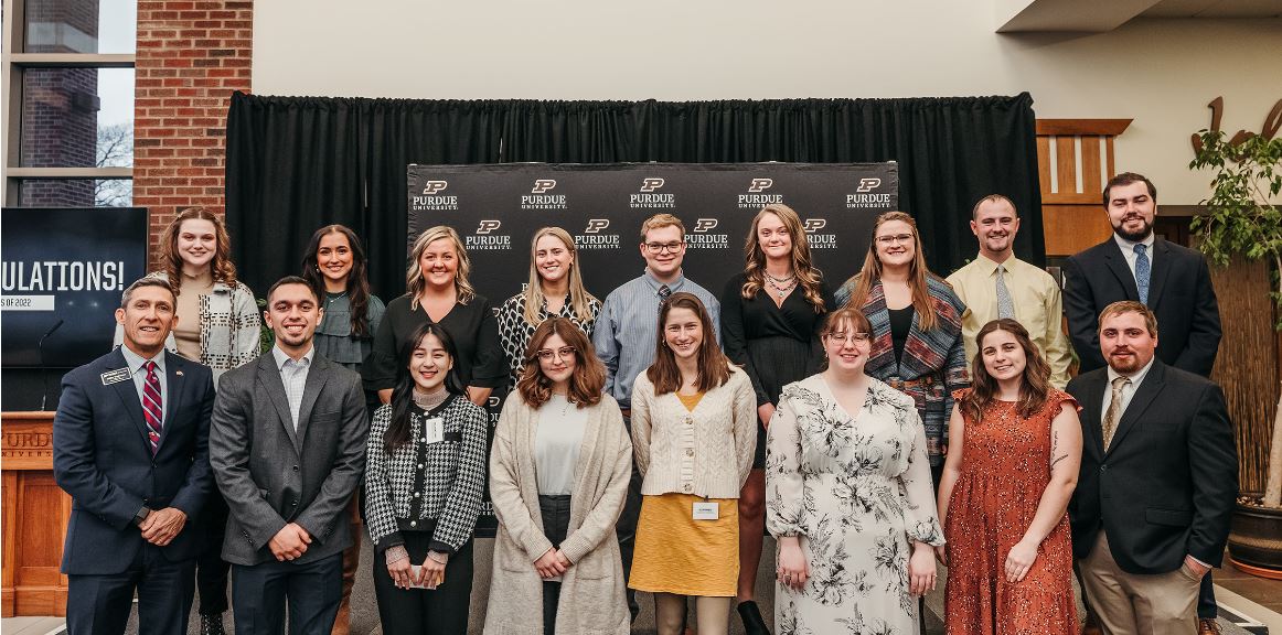 Interim Dean Phillip J. VanFossen with 16 of our newest graduates at the Dec. 16 pinning ceremony