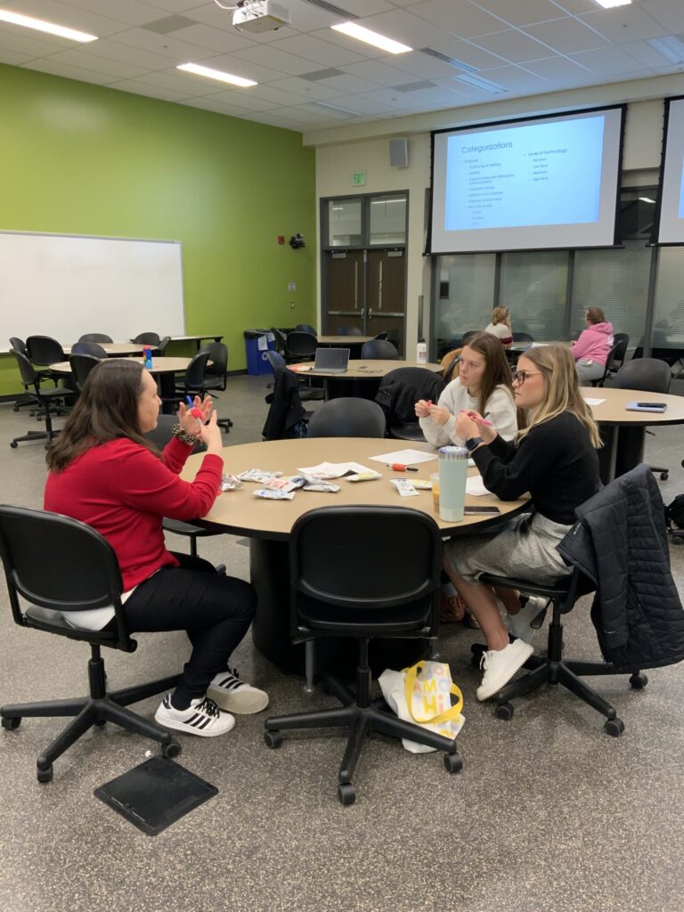 Students discuss a project around a table