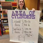 A student shows off their anchor chart