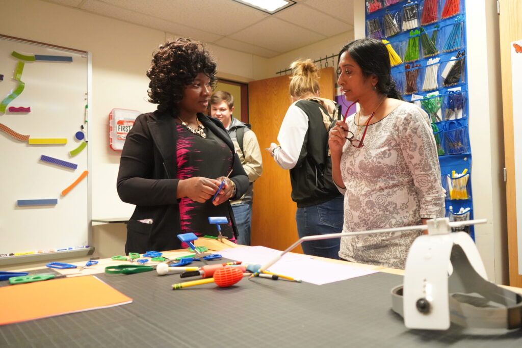 Visitors to CREATE chat around a table
