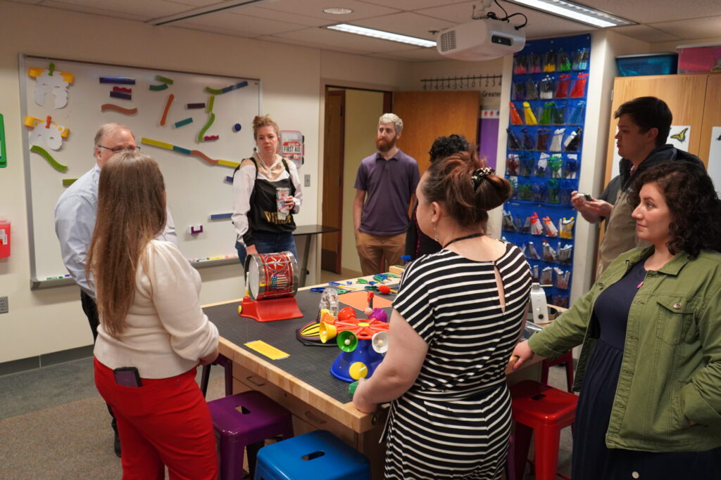Visitors talk in a group at the grand opening of CREATE