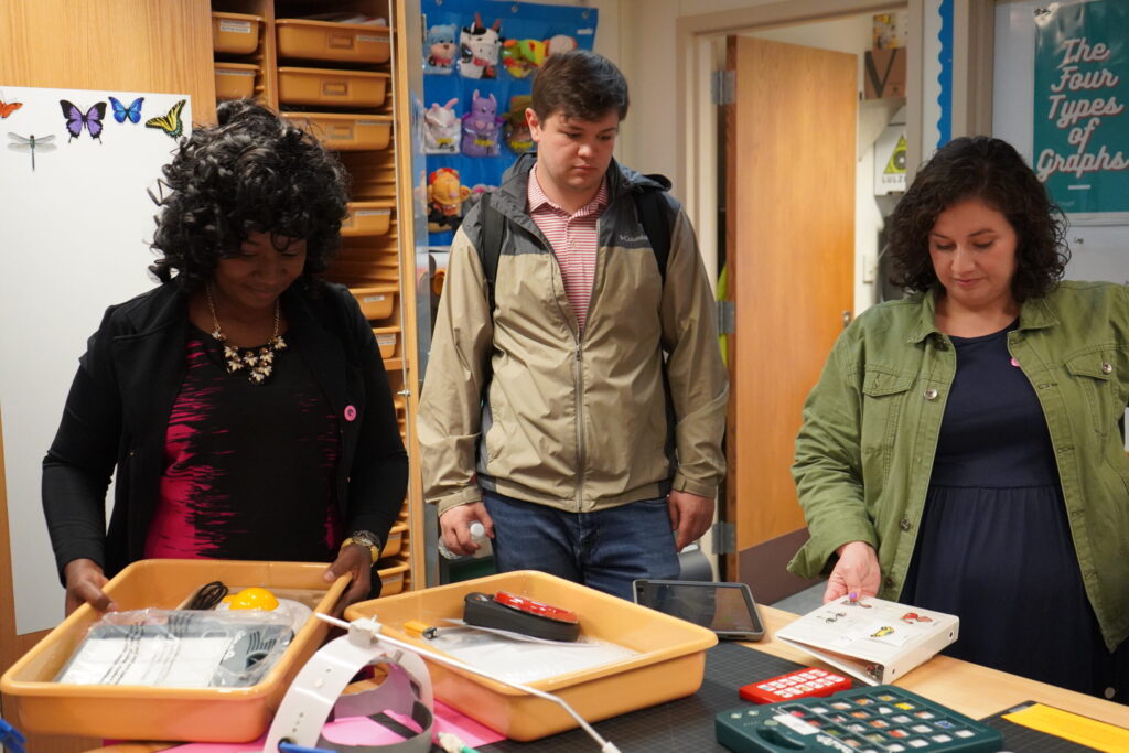 Visitors gather around a table at the grand opening of CREATE