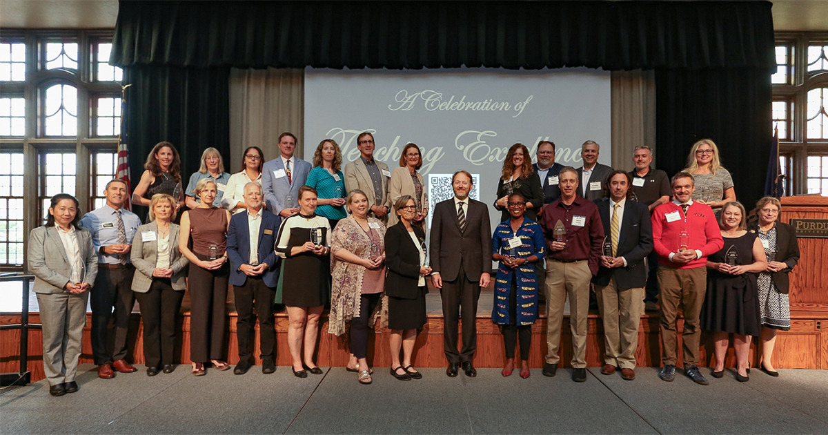 Provost Patrick Wolfe stands with Purdue instructors as they are inducted into the Book of Great Teachers