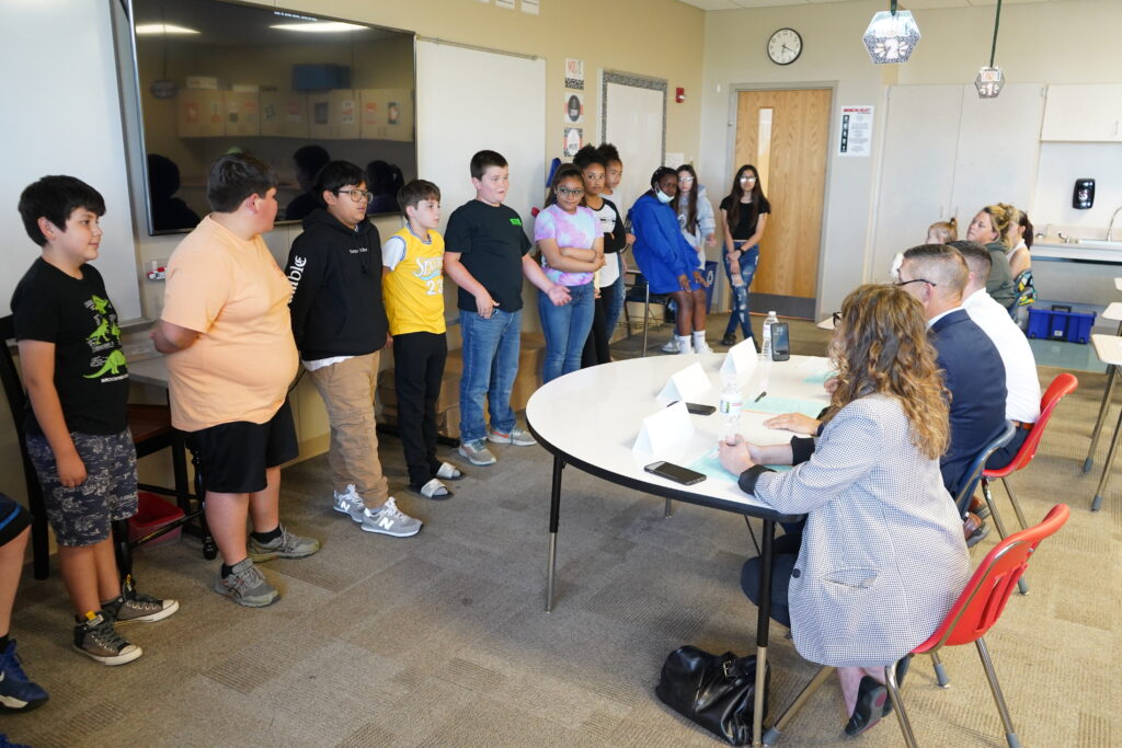 Project Citizen participants discuss their "Lowering the Working Age to 13" project with judges, including Phillip J. VanFossen, interim dean of the College of Education and director of the Ackerman Center.