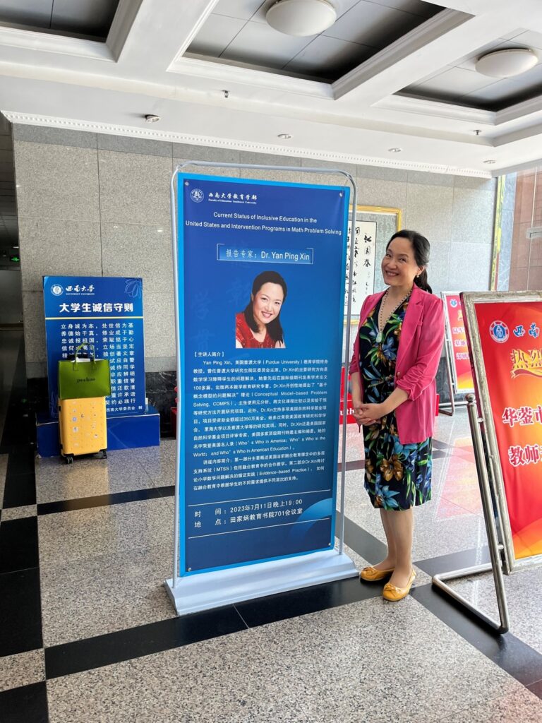Xin beside a poster announcing her research talk at SWU’s 
Global Immersion Program 