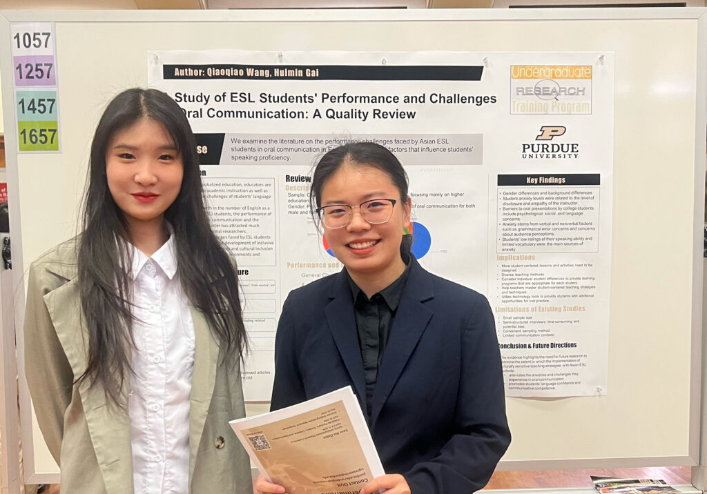 Qiaoqiao Wang and Huiman Gai standing in front of a poster titled Study of ESL Students' Performance and Challenges in Oral Communication: A Quality Review