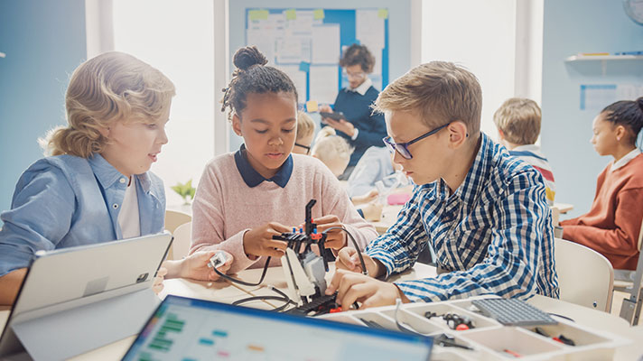 A group of students work on a robotics project.