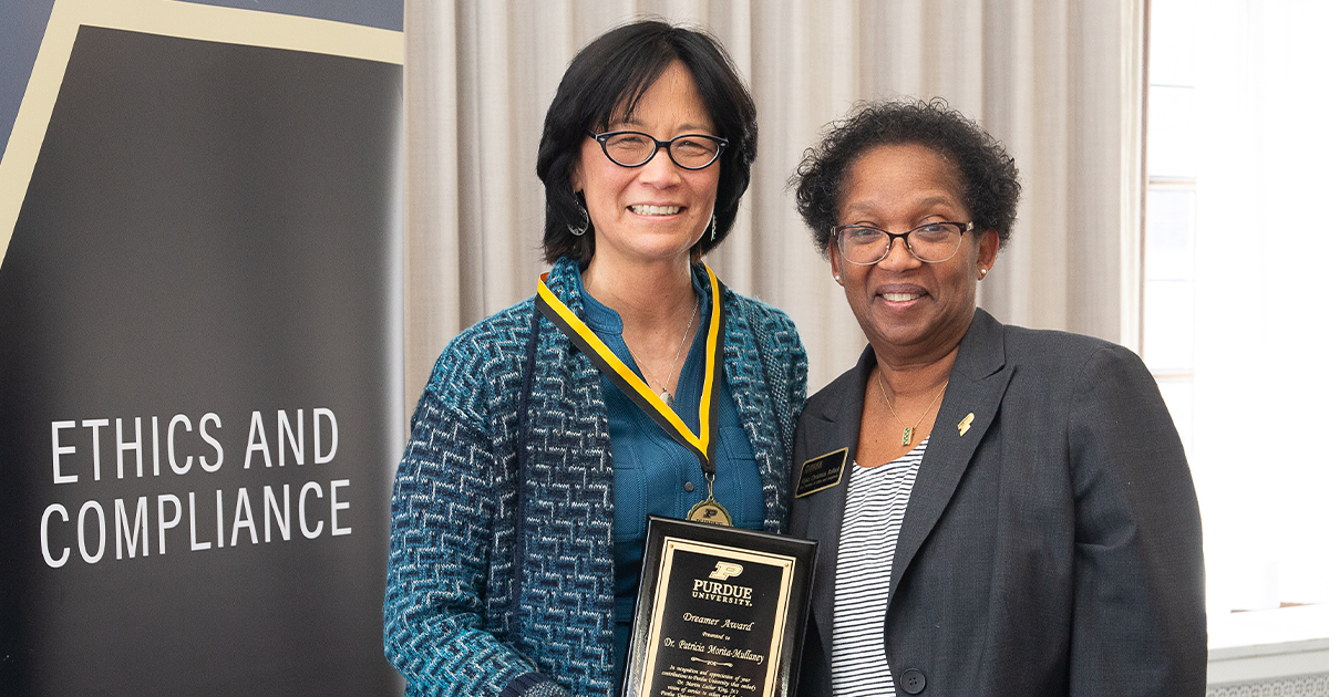 2024 Recipient Trish Morita Mullaney holding an award, standing next to Alysa Rollock.