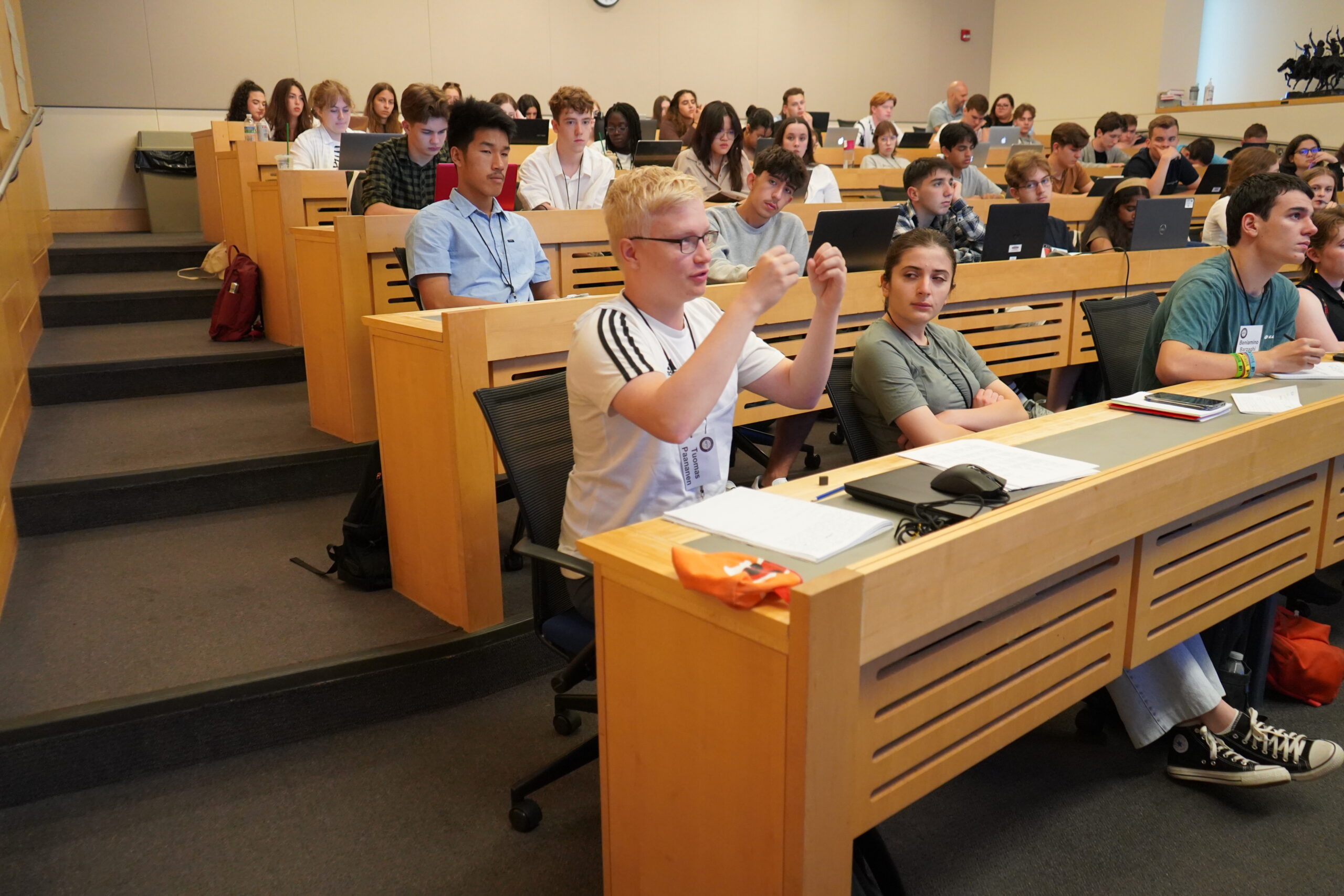 A group of students seated in a small lecture hall.