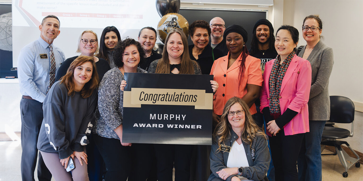 Jennifer Smith holding up a sign that says, 