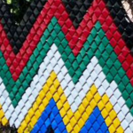 A fence decorated in a colorful zigzag pattern.