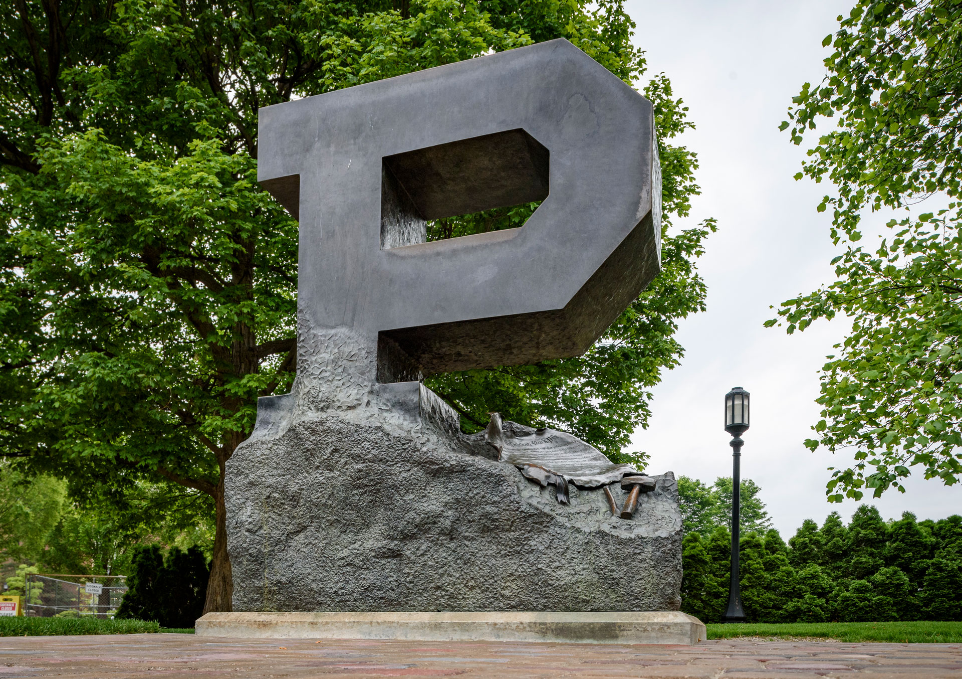 A "P" statue for Purdue University is seen in the foreground with yellow trees in the background.