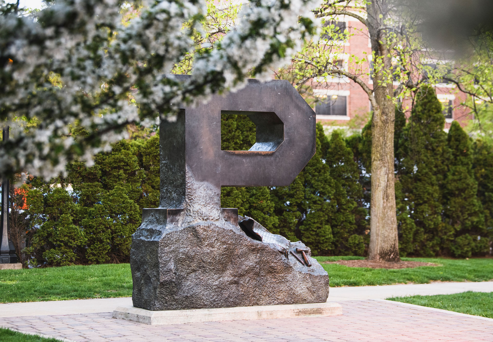 A "P" statue for Purdue University is seen in the foreground with yellow trees in the background.