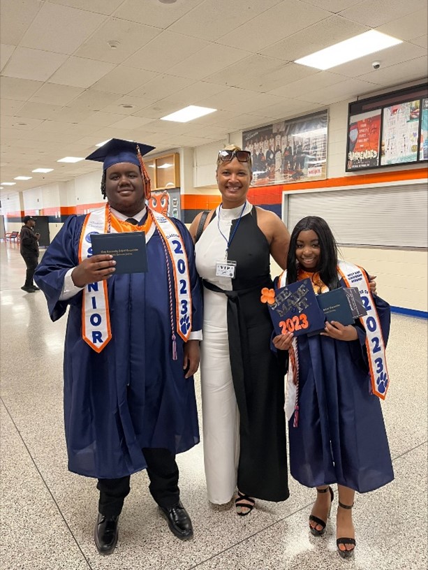 Anita Henderson-Johnson, the INGU regional director, poses with INGU high school graduates 
at West Side Leadership Academy in Gary, Indiana.