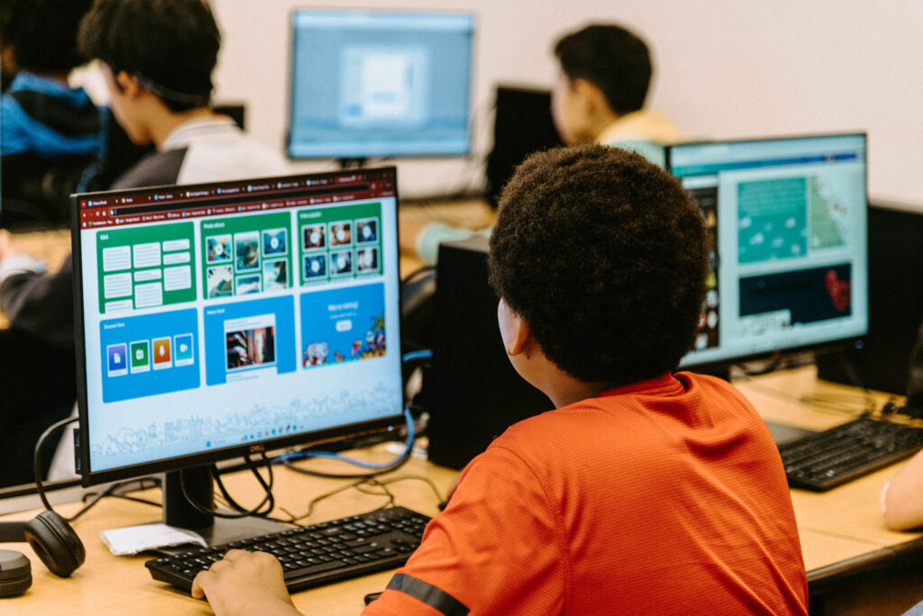 An over-the-shoulder view of a student using a computer.