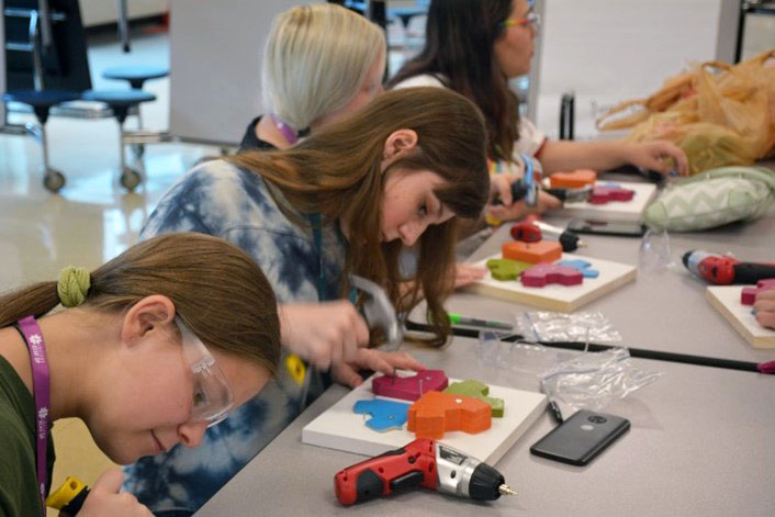 INGU students doing a woodworking project during a summer STEM camp.