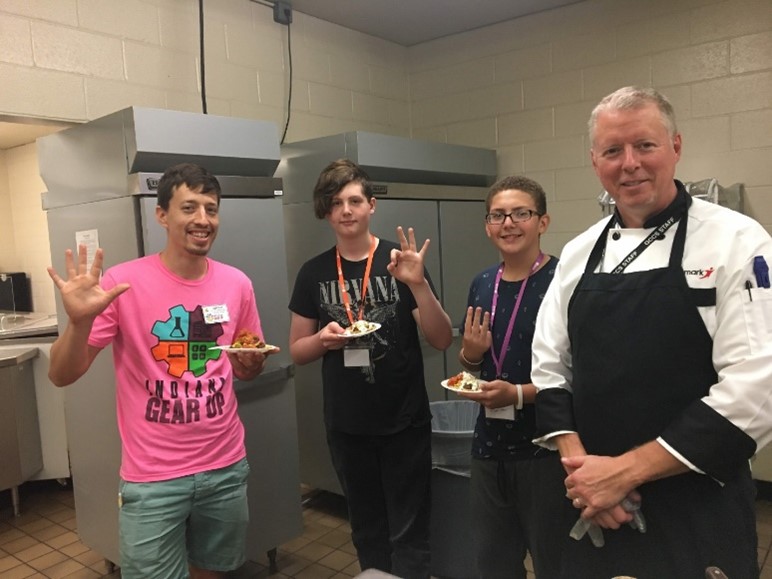 INGU students gain experience in the kitchen with the lead chef from Aramark during a summer STEM camp.