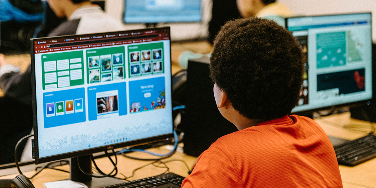 An over-the-shoulder view of a student using a computer.