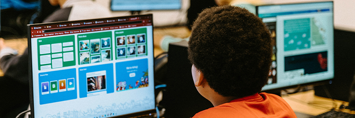 An over-the-shoulder view of a student using a computer.