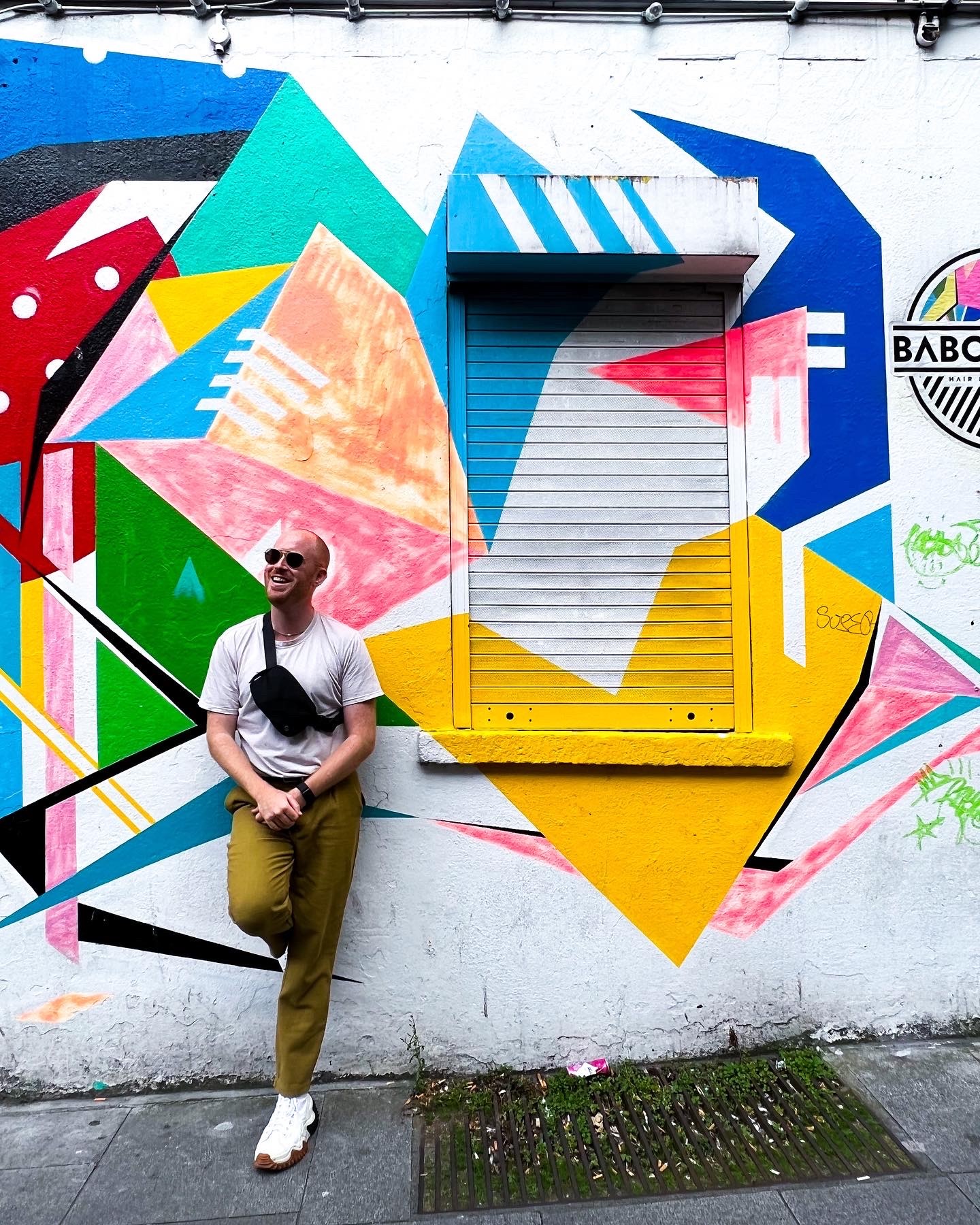 Ricky Pride in front of a colorful wall.