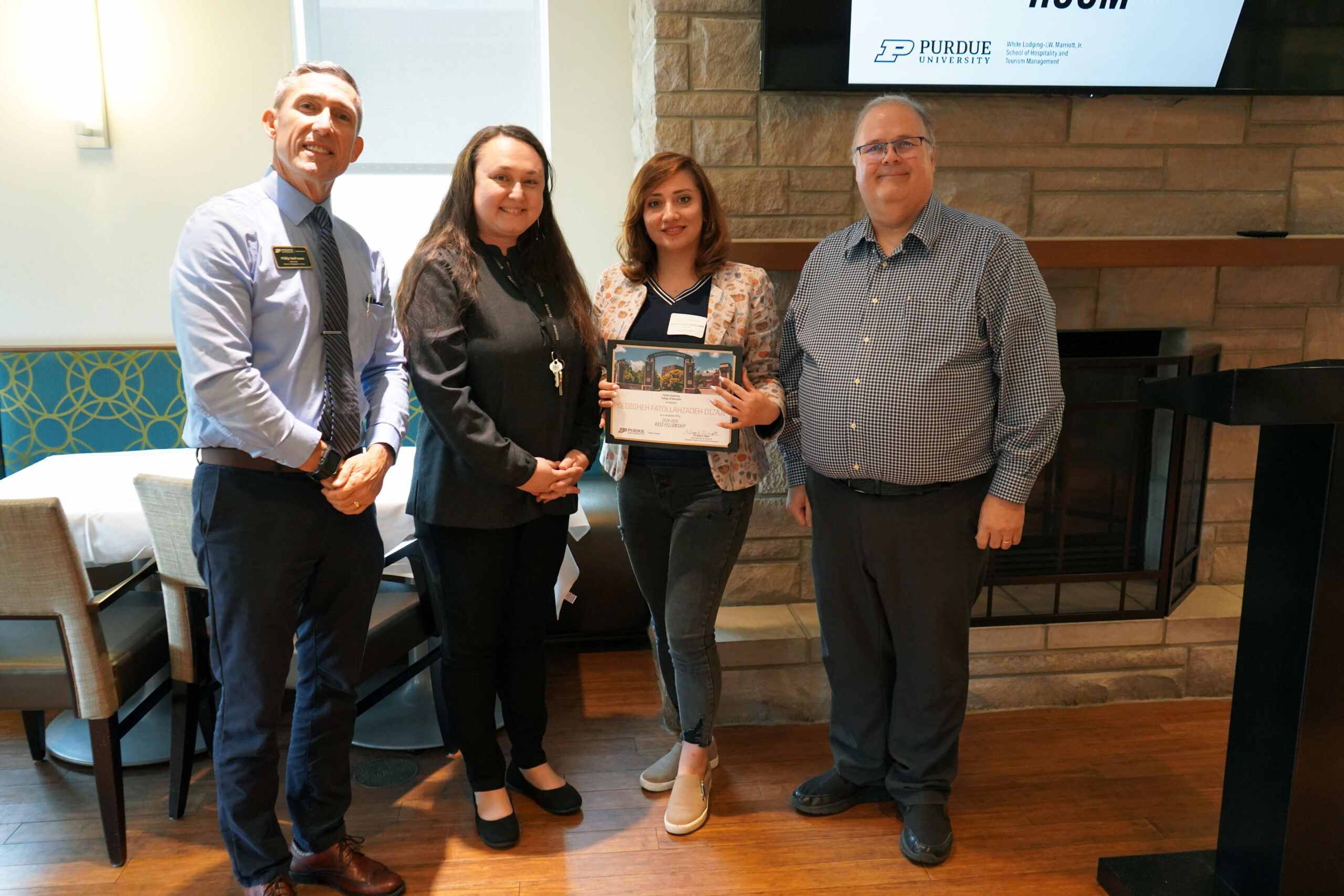 Sedigheh Fatollahzadeh Dizaji holding a certificate. Surrounding her are interim dean Phillip J. VanFossen, Dr. Jasmine Begeske, and Dr. Wayne Wright.