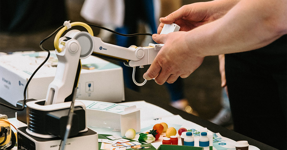 Two hands operating a pair of technological equipment.