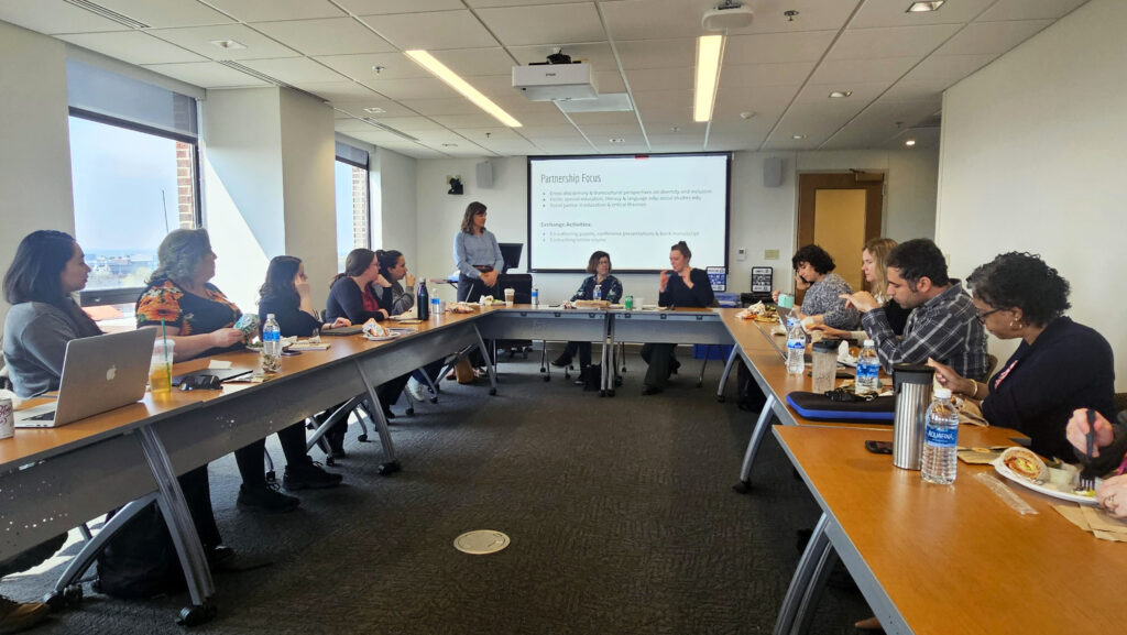 Lunch & Learn attendees seated at a U-shaped table.