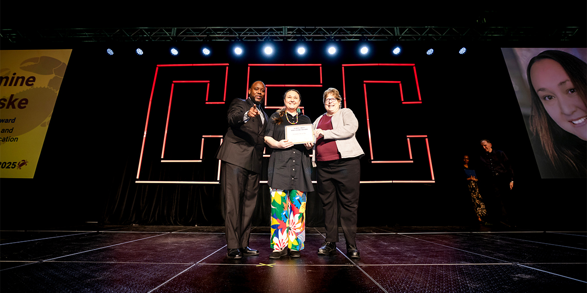 Jasmine Begeske holding a certificate on the CEC stage. Surrounding her are Susan Harvey and Kareem L. Thompson.