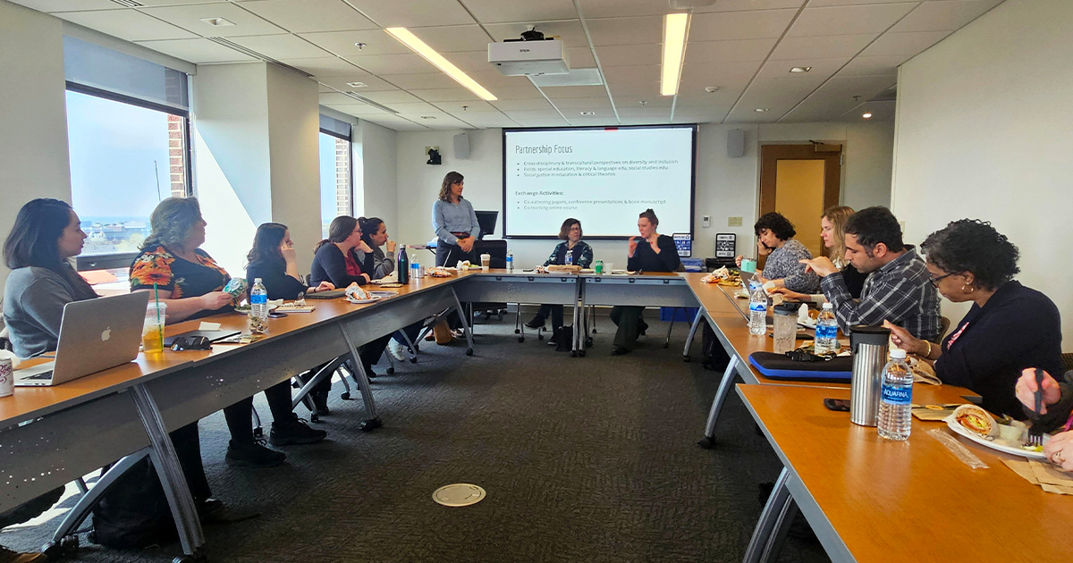 Lunch & Learn attendees seated at a U-shaped table.