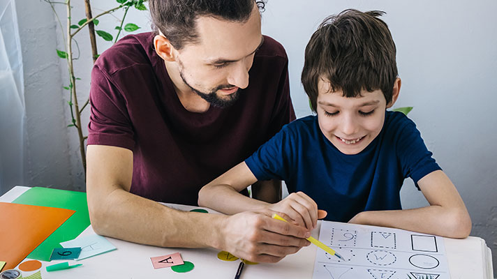 A teacher works with a student with autism