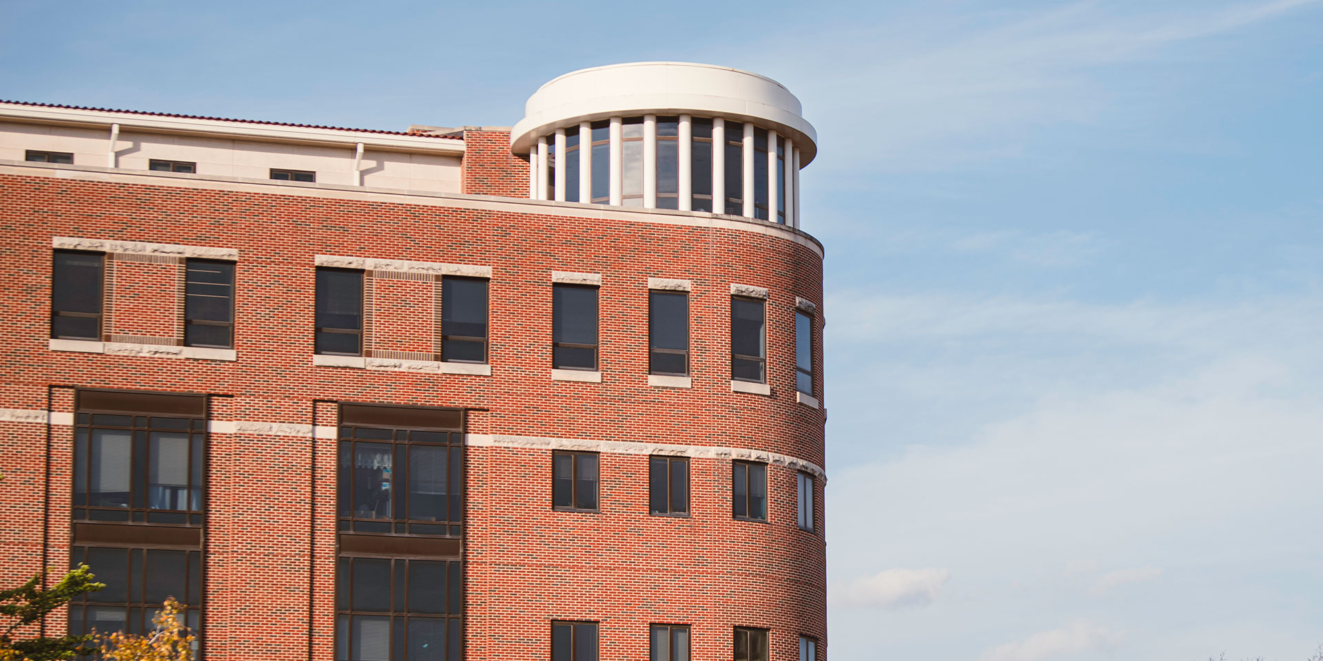 The top of Beering Hall in front of a blue sky.