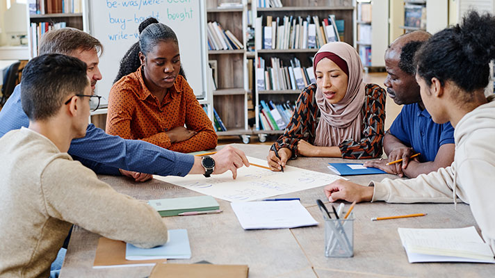 Students work on a group project in the library
