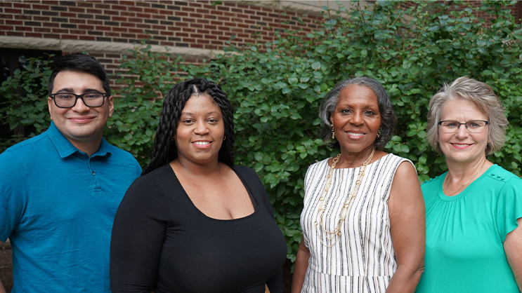 The Office of Advising staff smiling for a team photo outside. 