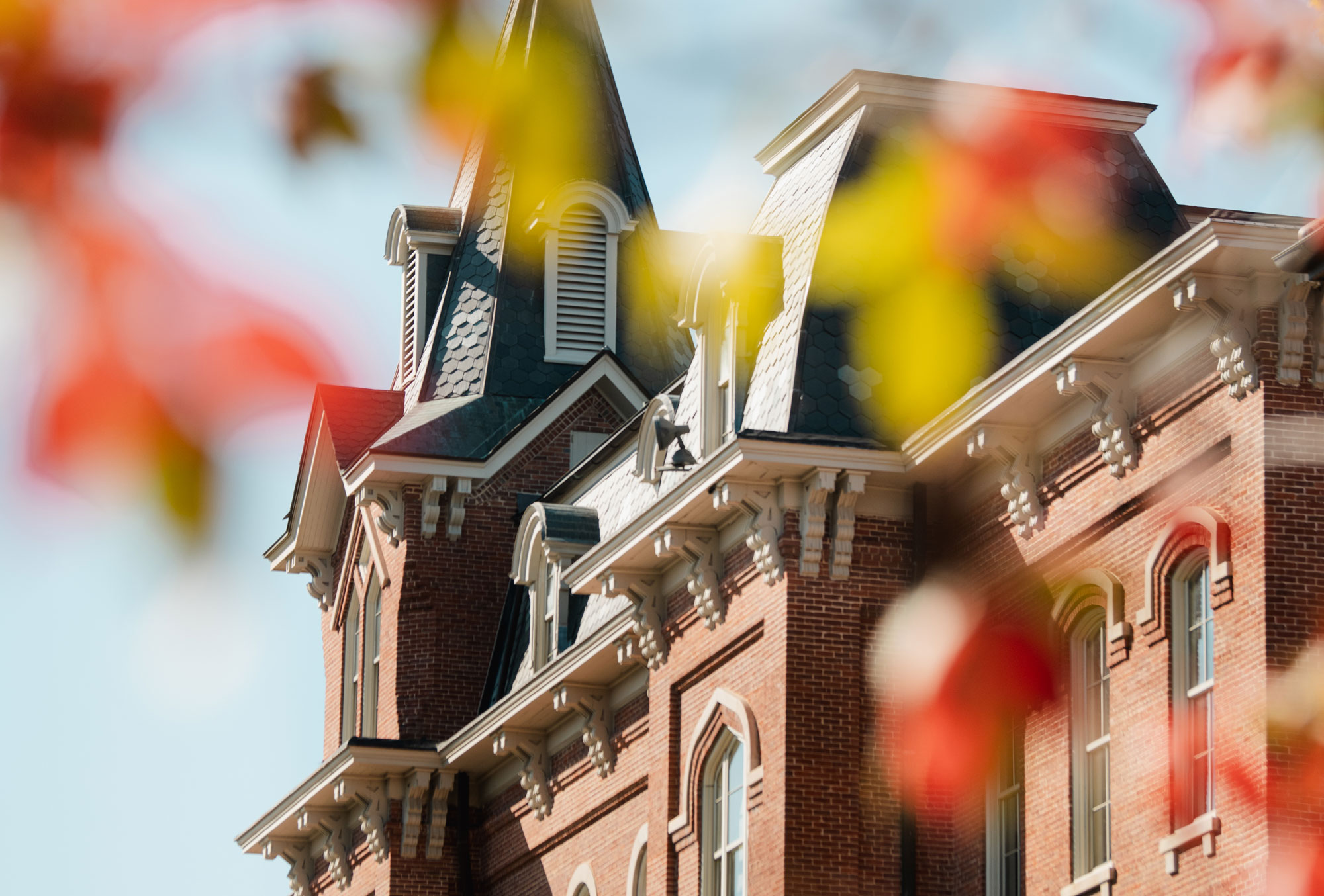 A view through leaves of the oldest building on Purdue University's campus