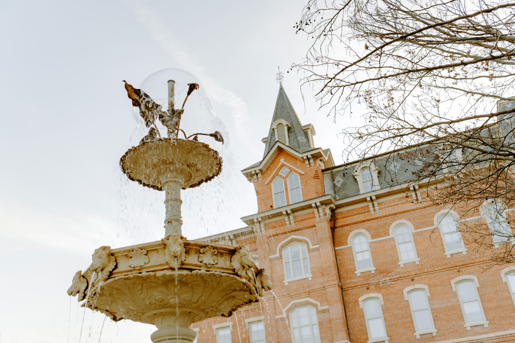 A scenic fountain stands in front of the oldest building on Purdue University's campus
