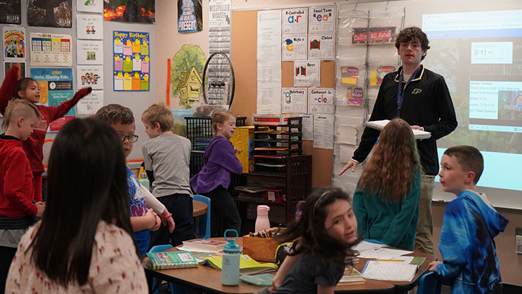 A Purdue student teacher speaks in front of a classroom