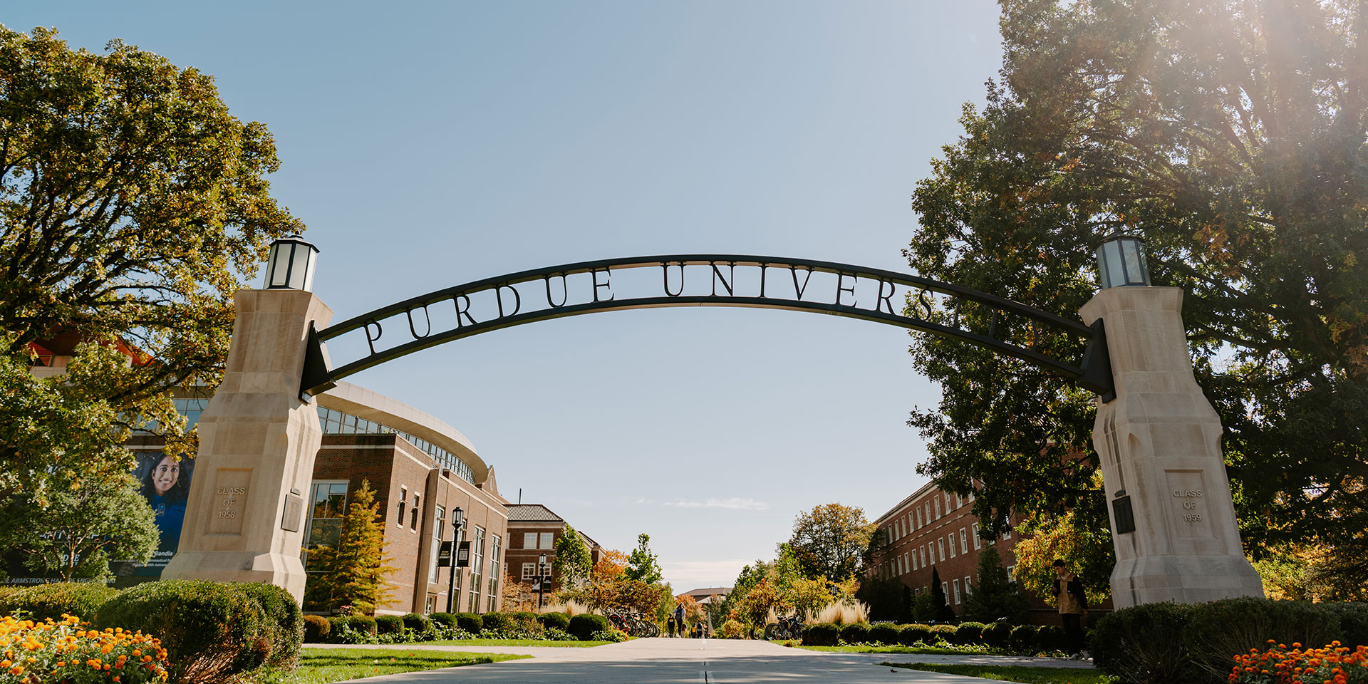 A metal arch gateway that says Purdue University on Purdue's campus