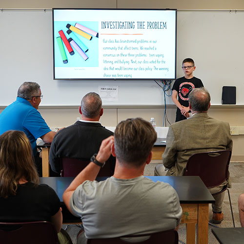 A young student presents at a Project Citizen event