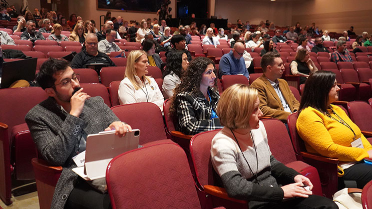 Audience members at the Purdue AI in Education Conference watch the keynote speaker