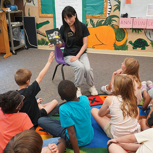 A Purdue researcher reads to a group of students in a classroom