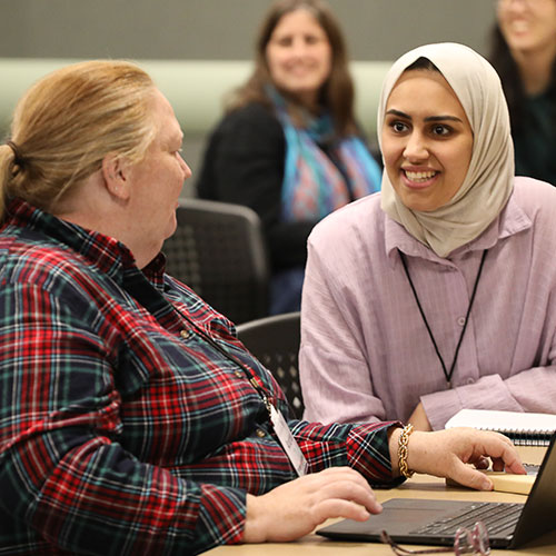 Two attendees at the ICLCLE conference talk between sessions