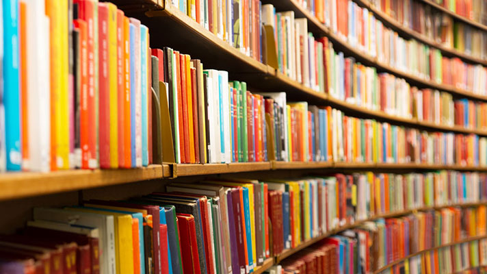 Books line the shelves in a library