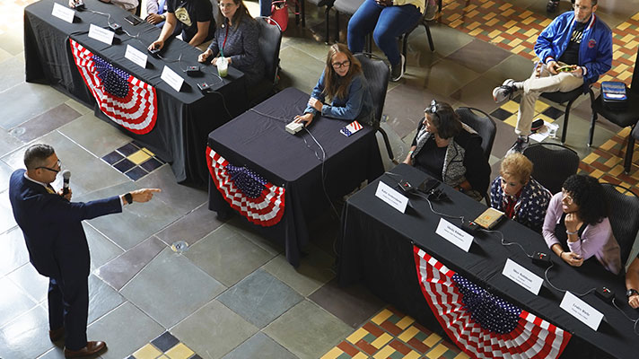 A presenter talks to a group at Constitution Day