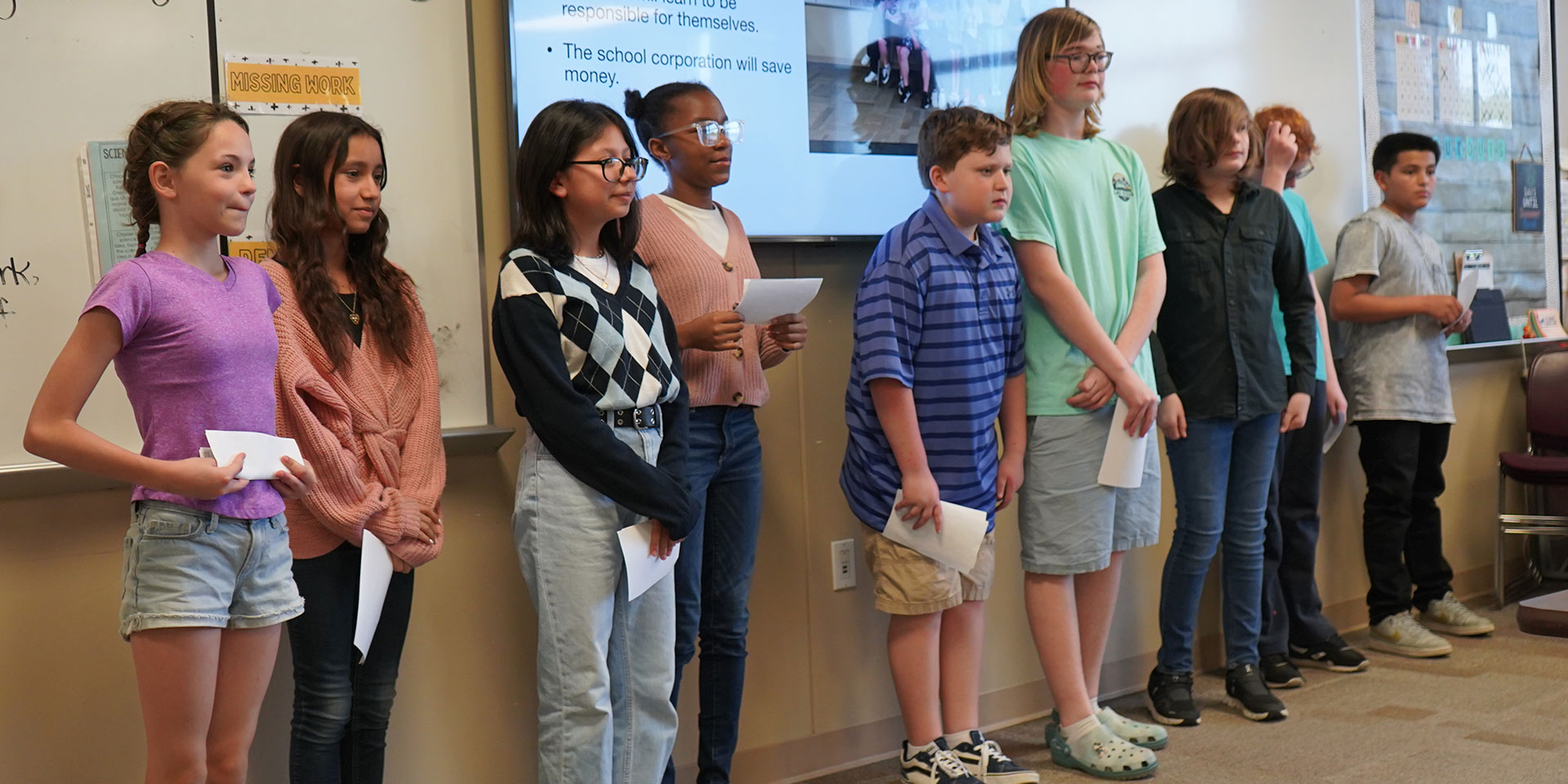 Young student stand in front of the classroom presenting a civics lesson