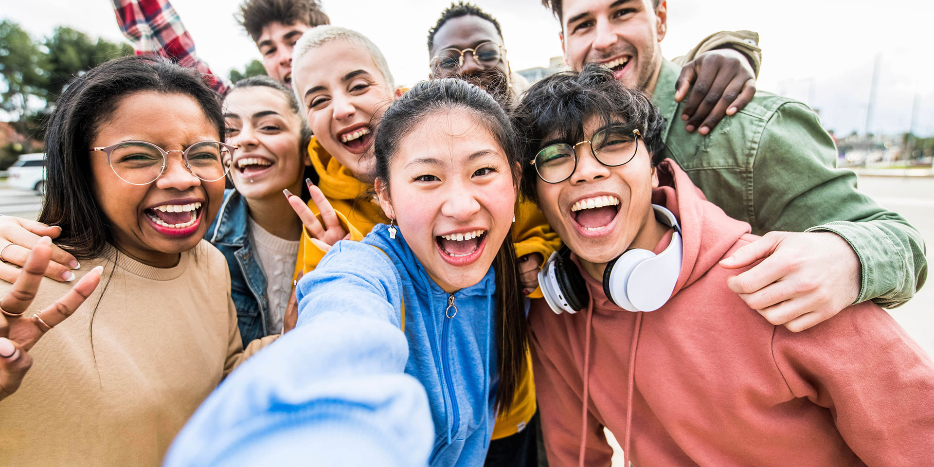 A group of diverse students take a selfie