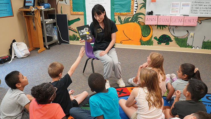 A Purdue Freedom School volunteer reads to students during the program